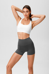 Fitness woman. Athletic girl on the gray background