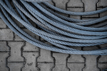 Coiled Steel Winch Cable on Paving Stones