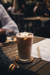 Glass of Ice Coffee on a Wooden Table at a Restaurant