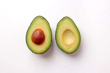 Avocado cut in half on white background