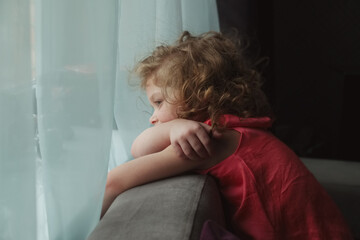 Girl waiting for someone and looking out the window.