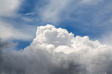 The top of a cumulus cloud in white daylight among the sky and clouds, close-up, clouds up close, view in the sky among the clouds.