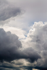 Large cumulus gray clouds filled the sky vertical shot close-up, clouds before the storm, large waves of clouds close-up in the sky, approaching storm and sharp weather change.