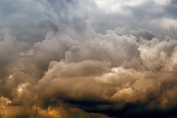 Heavy stormy textured clouds in yellow-blue tones in the sky close-up, a heavenly landscape with...
