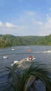 Central Java June 25, 2025: Natural Sensation: The Roar of Speedboats on a Lake Surrounded by Beautiful Mountains, Central Java, Indonesia