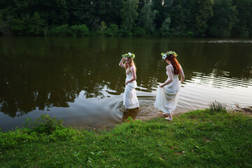 Romantic midsummer celebration with floral crowns and barefoot walk into calm lake waters.