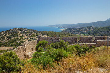 Historic Kritinia Castle on top of hill in Rhodes island, Greece. Idyllic countryside nature and Aegean sea seen from distance, blue sky. Castle of Kritinia also known as Kastello.