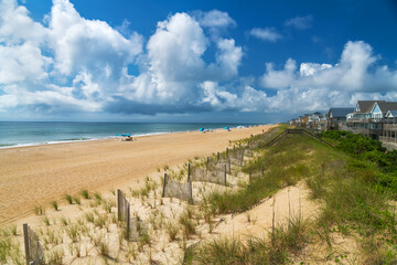 Sand dunes and Rows of beach houses on stilts on the Atlantic shore.