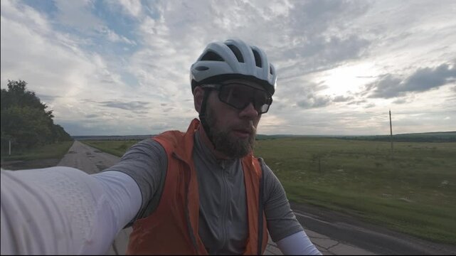 cycling in nature in wild places, bike-packing. A blogger makes a video for social media about his journey