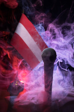Microphone on a background of a blurry flag of Austria close-up. dark table decoration