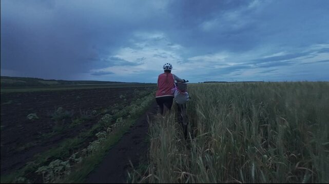 cycling in nature in wild places, bike-packing. Driving through the field at night