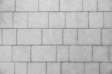 Gray concrete pavement tiles arranged in geometric pattern, top view of modern paving surface for urban and residential design