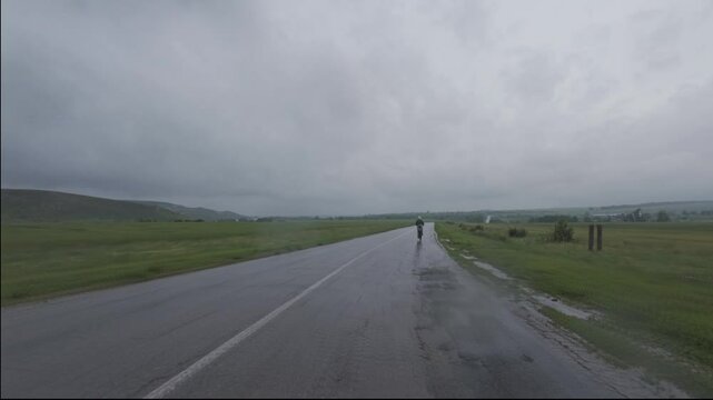 cycling in nature in wild places, bike-packing. Driving in cloudy weather in the rain