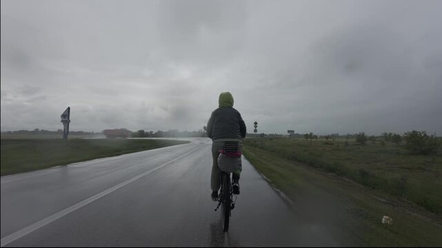 cycling in nature in wild places, bike-packing. Driving in cloudy weather in the rain