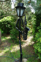 Unusually shaped wrought iron lanterns in the garden.
