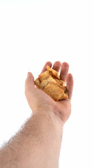 Hand holding snacks on white background