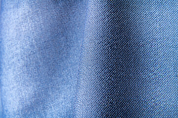 Textile close-up of blue fabric with even weave and light shadows showing detailed surface texture for textile and design themes