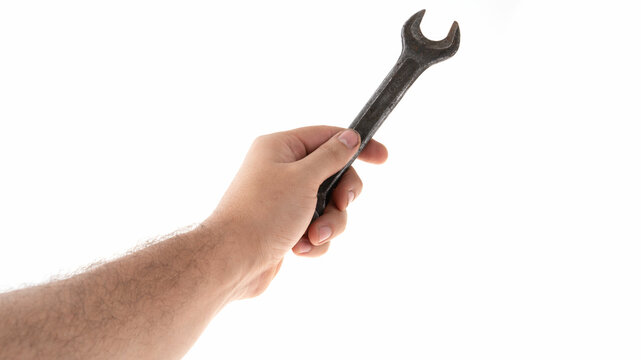 Hand holding a wrench against a white background