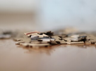 Jigsaw puzzle pieces on the table closeup photo 