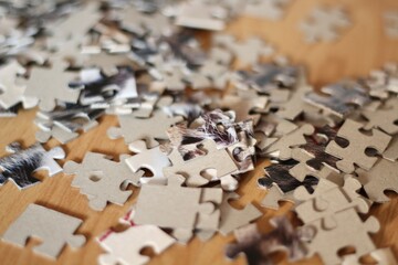 Jigsaw puzzle pieces on the table closeup photo 