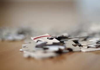 Jigsaw puzzle pieces on the table closeup photo 
