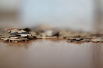 Jigsaw puzzle pieces on the table closeup photo 