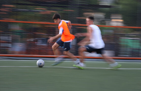  teens  boys plays football at a sports school .Blur