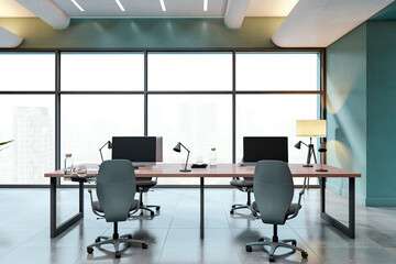 Modern office interior with desks, chairs, computers and lamps in front of large glass windows overlooking city buildings in daylight. 3D Rendering