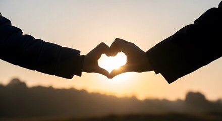 Silhouette of hands forming a heart shape against a serene sunrise backdrop, symbolizing love, connection, and the beauty of shared moments in a natural setting.