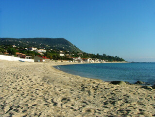 Beautiful view of the sea coast in Calabria, showcasing crystal-clear blue waters gently meeting...