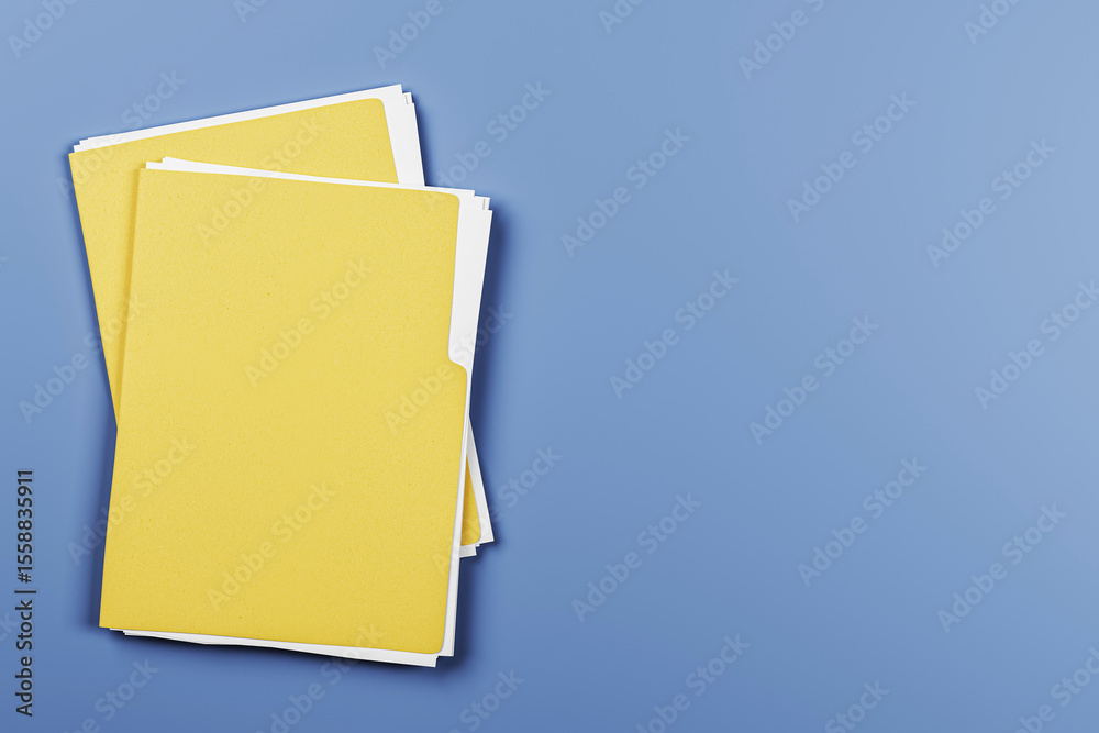 Poster Yellow document folders stacked on desk with copy space on blue background. Clean top view for office branding or business presentation template. 3D Rendering
