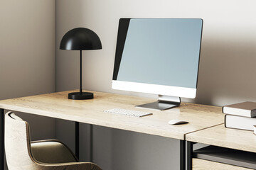 Fototapeta premium Modern workspace with blank screen desktop computer, wooden desk, black lamp, and cozy armchair in home office corner environment setup. 3D Rendering