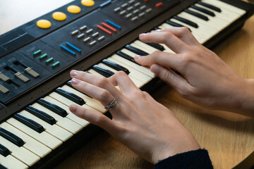 Capturing the essence of electronic music, musician's hands skillfully playing a vintage...