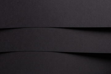 Geometric abstract designer paper texture with dark, monochrome backdrop. Minimalistic, chic surface