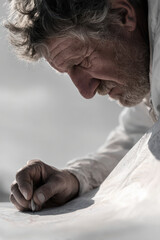 focused seismologist analyzing seismic activity records portrait on left side of frame hands out of shot