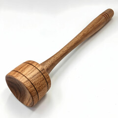 A wooden masher, placed diagonally, is a traditional kitchen tool used to crush