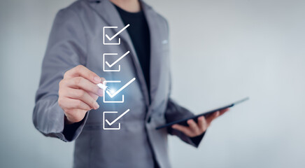 Businessman mark checkboxes, Survey form, check marks on checklist,Checklist concept.
