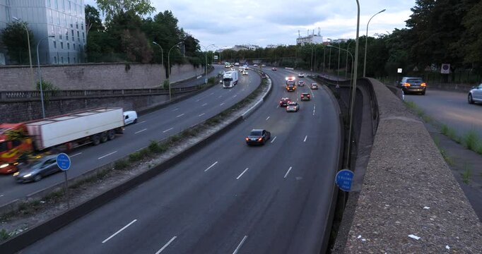 A view of the Parisian ring road at Porte Dorée Gate, from above and in the evening. Paris, France - July 22, 2024. 