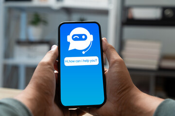 Businessman uses smartphone with AI interface for accessing virtual assistants,chatbot,Intelligent service.Concept integration of machine learning and artificial intelligence in digital communication.