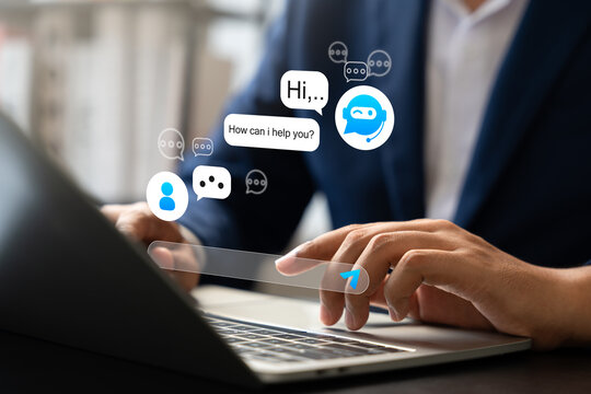 Businessman interacts with AI chatbot on laptop, Automated conversations in digital business. Concept includes virtual support, Customer communication, Smart service through artificial intelligence.