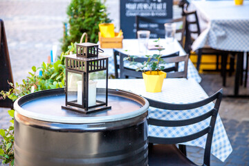 Lamp lantern outdoor empty Cafe Seating. Chairs and tables. Old tourist town in summer street bar