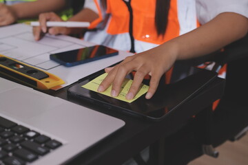 Closeup of team of industrial engineers meeting analyze machinery blueprints consult project on...