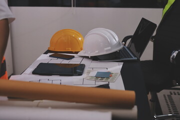 Closeup of team of industrial engineers meeting analyze machinery blueprints consult project on...