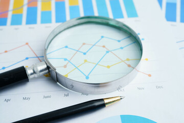Magnifying glass on charts graphs paper. Financial development, Banking Account, Statistics,...
