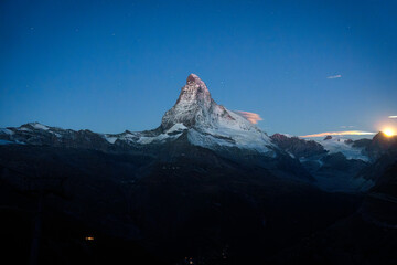 Matterhorn mountain with moonlight glowing in the dusk at Switzerland