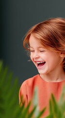 Naklejka premium Portrait of a Laughing Child with Red Hair and Orange Shirt Outdoors