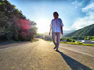 Middle-aged woman blogger exploring scenic landscapes on a sunny afternoon during her travel...
