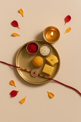 Obraz premium Decorative Rakshabandhan Thali with Diya and Petals