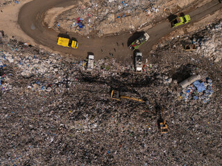 Trucks are collecting waste in large piles for disposal and recycling.