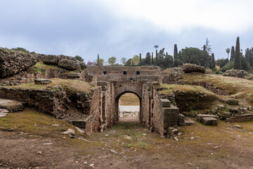 Ruins of the mérida roman amphitheater showing vomitorium under cloudy sky